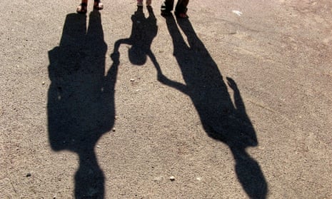 Shadows of a family holding hands