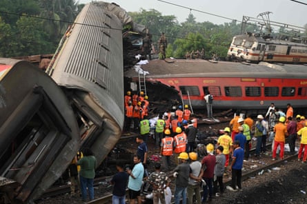 Rescue workers including soldiers stitchery astir damaged carriages astatine the mishap site