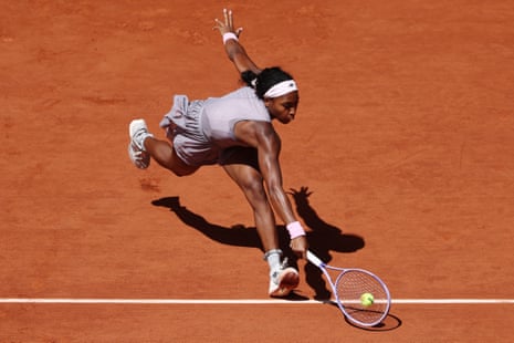 Coco Gauff stoops for a return.