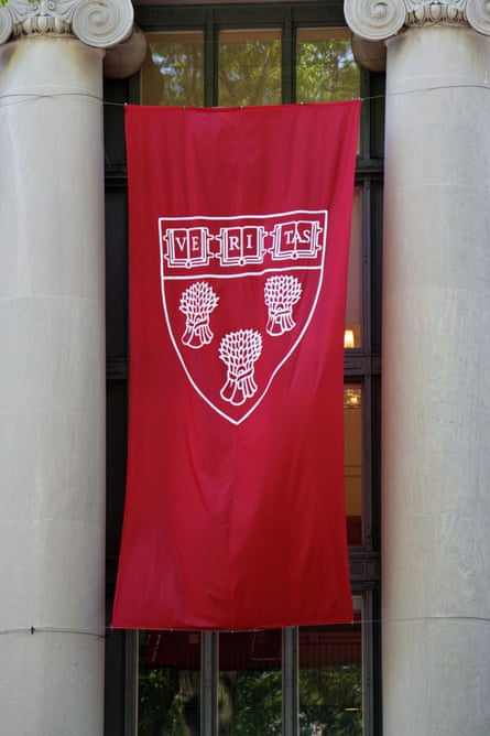 A red banner with Harvard’s coat of arms