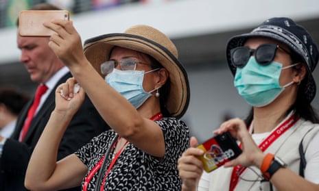 Spectators wearing protective masks at the Singapore Airshow on 11 February.