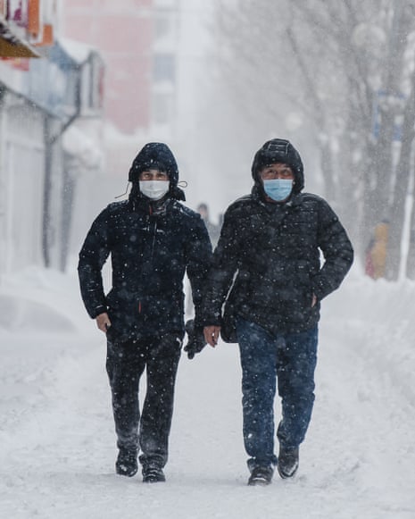 Covid live: Poland, Slovakia and Iceland latest countries set to end most coronavirus restrictions — as it happened 5 People walk in a street during a snowfall in Sakhalin, Russia.