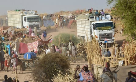 Two trucks carrying humanitarian aid arrive at a camp for displaced people