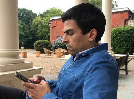 Ammar Kalia scrolling on his phone.
