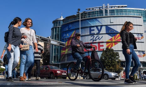People in Skopje, North Macedonia, walk past the offices of the European Union with logos reading ‘EU for You’
