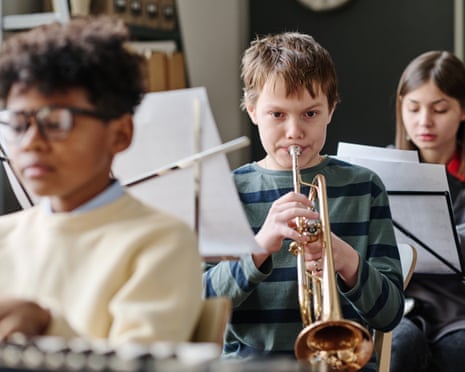 Boy playing trumpet in school orchestra