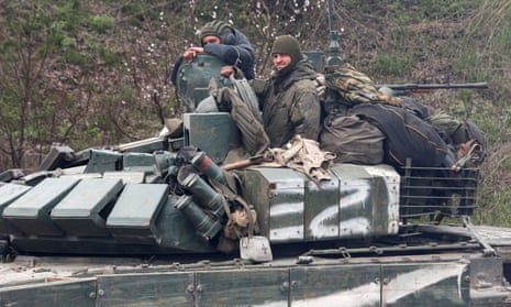 Russian troops drive an armoured vehicle near the southern port city of Mariupol.