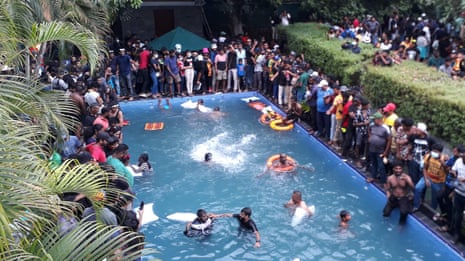 Sri Lanka protesters jump into president's pool after storming palace in Colombo – video