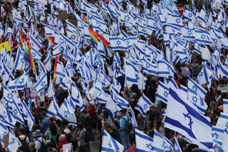 Protesters gather with national flags outside the Knesset, Israel’s parliament, in Jerusalem.