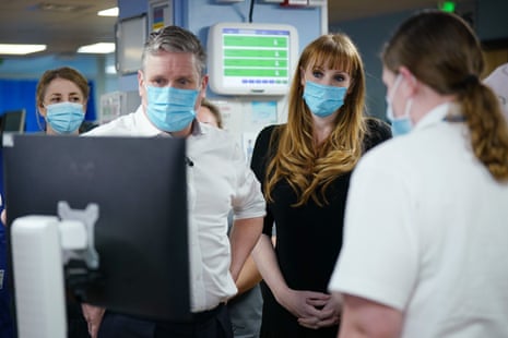 Starmer and Rayner talking to staff in the emergency department.