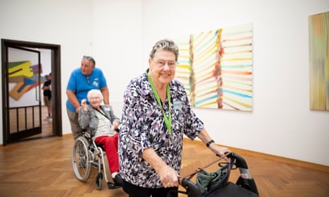 Annie Versteeg is followed by Bwieuwkje Bruinenberg-Haisma, being pushed in a wheelchair by her son Harry, through Kunstmuseum Den Haag.