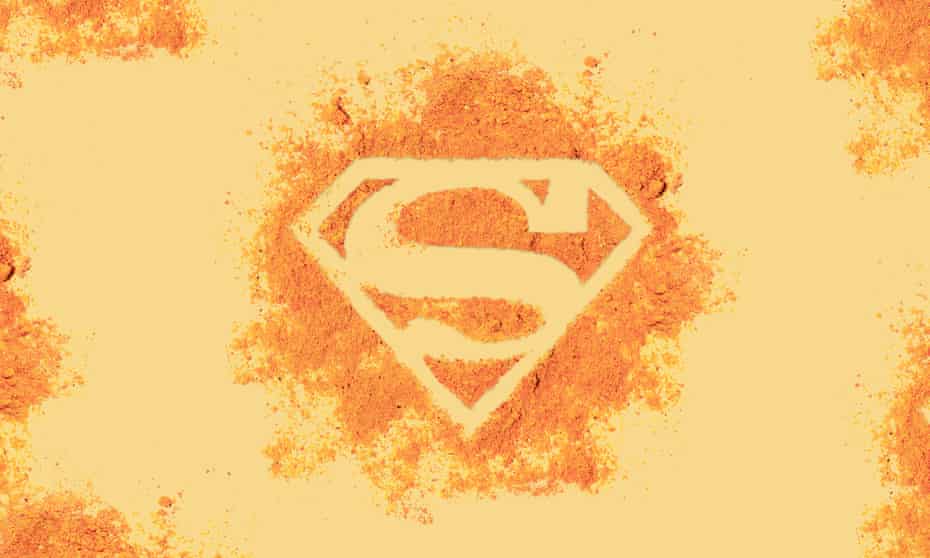 Superman logo formed out of turmeric powder