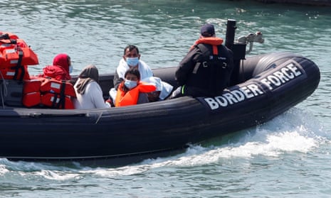 Migrants in a border patrol boat at Dover harbour.