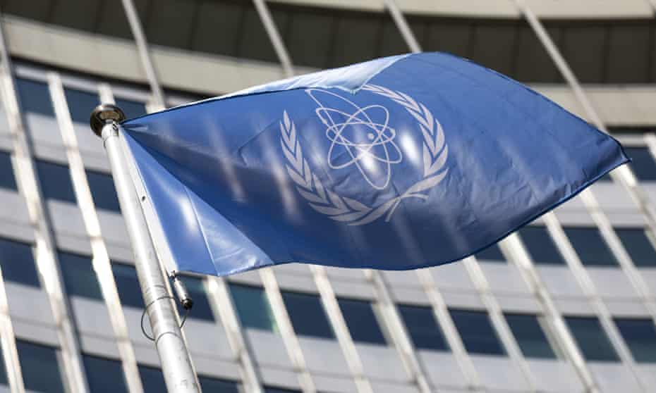 The flag of the International Atomic Energy Agency waves at the entrance of the Vienna International Centre