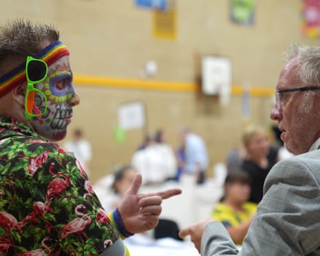 Candidate Glenn Cummings (left) looks on as votes are counted