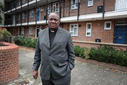 A revered stands outside a block of flats