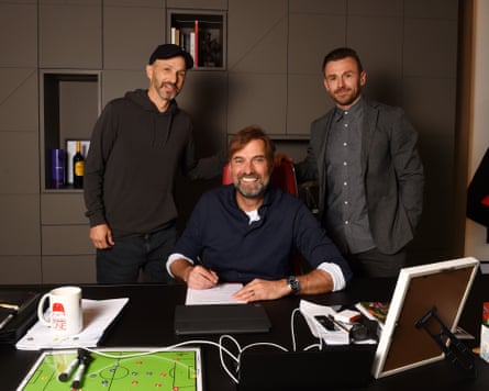 Jürgen Klopp signs a contract extension in April 2022 with FSG’s Michael Gordon (left) and Julian Ward, then Liverpool’s assistant sporting director.