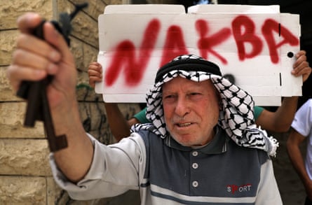 A Palestinian man marks the 72nd anniversary of Nakba in Hebron in May last year. The key symbolises the home he left behind in 1948.