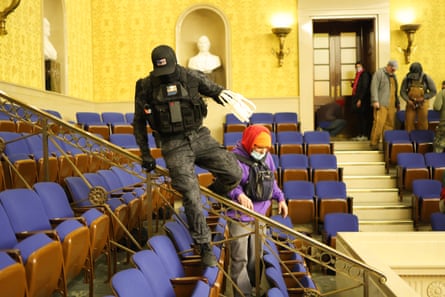 a man tactical gear jumps over a banister