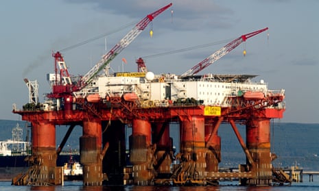 A Flotel, the Borgholm Dolphin, is towed past the Nigg Oil Terminal, in the Cromarty Firth, Scotland