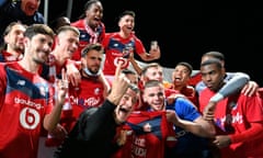 Lille coach Christophe Galtier celebrates the title with his players.