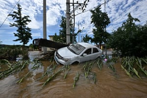 A damaged car in a flooded neighbourhood in Miyun district, northern Beijing.