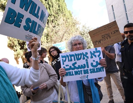 People protest outside the Israeli high court in support of granting Arab parties the right to run in the upcoming general elections, holding signs saying 'I will not be silent'