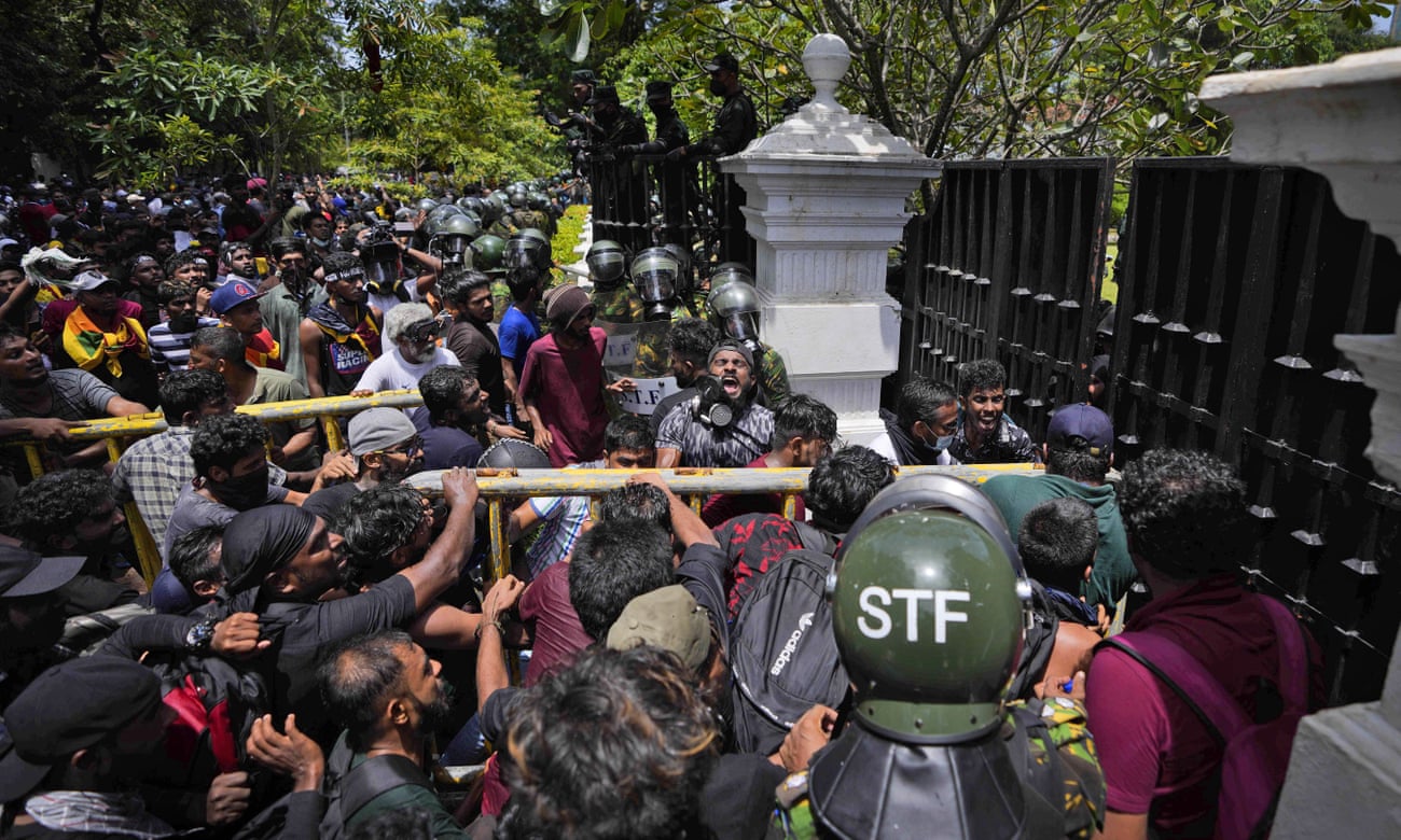 Protesters try to break the gates at the compound housing the office of Sri Lanka’s prime minister, Ranil Wickremesinghe.