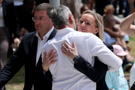Leader of Australia’s Liberal Party Sussan Ley (R) embraces Co-CEO of the executive council of Australia Jewry Alex Ryvchin (C) at the Bondi Pavillion