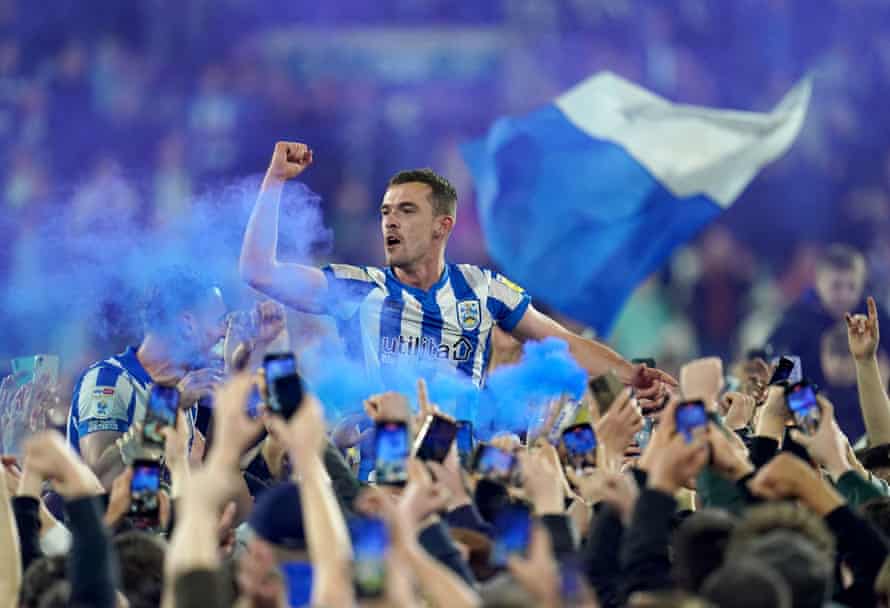 Huddersfield Town’s Harry Toffolo is carried by fans after victory in the playoff semi-final.