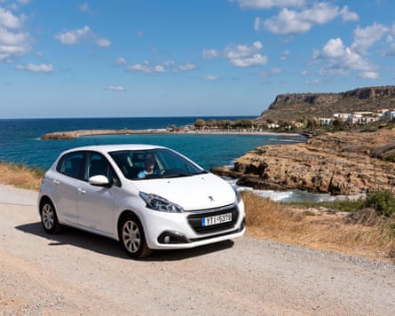 Female tourist driving a white car in Crete
