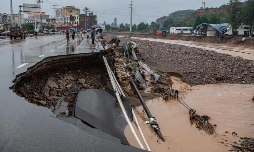 A flooded street sinks into a hole at Mihe town on July 21, 2021 in Gongyi, Henan Province of China. Mihe town in Gongyi city, which is administered by Zhengzhou, is one of the hardest-hit areas
