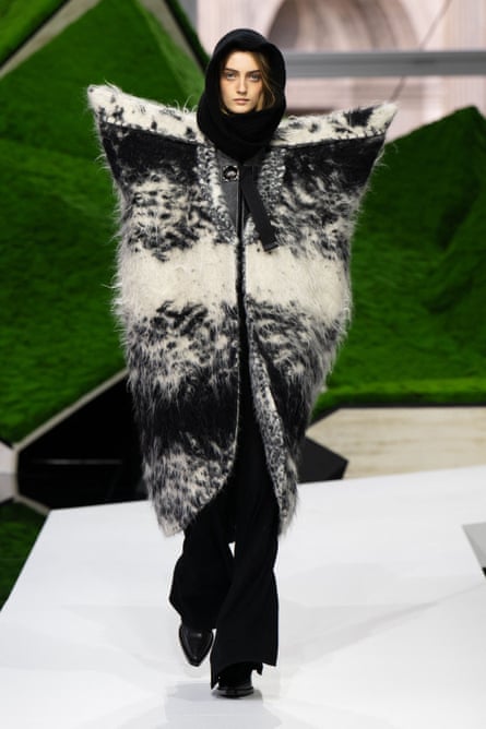 Model wears jacket with very large shoulder pads.