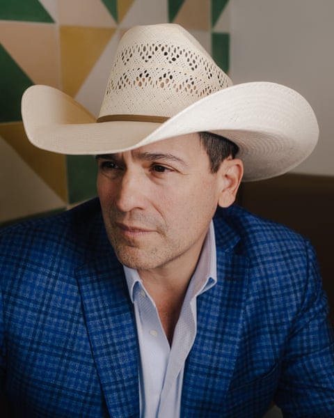 Man in cowboy hat poses for portrait