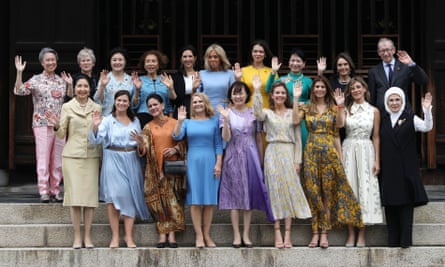 Awkward: Philip May, back right, poses with the other all-female spouses of world leaders at the G20 summit in Kyoto in 2019.