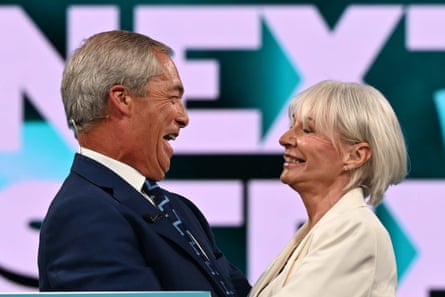 Nigel Farage and Nadine Dorries greet each other on stage