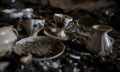 A tea set on the floor of a burned apartment which was damaged during the battles of spring in Mariupol.
