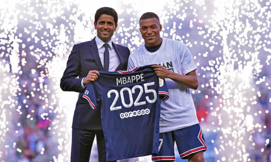 Kylian Mbappé poses with the PSG president, Nasser Al-Khelaifi, after extending his contract with the Ligue 1 club.