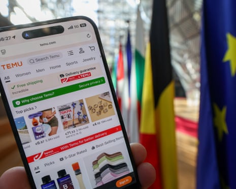 The Chinese online marketplace Temu is displayed on a smartphone screen in front of European Union flags in Brussels, Belgium.