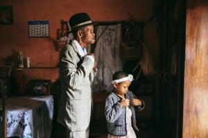 Dada Paul Rakotazandriny, 91, who is living with dementia, and his granddaughter, Odliatemix Rafaraniriana. 5, get ready for church on Sunday morning at his home in Antananarivo, Madagascar, 12 March 2023