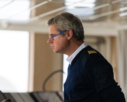 A middle-aged man on the bridge of a ship