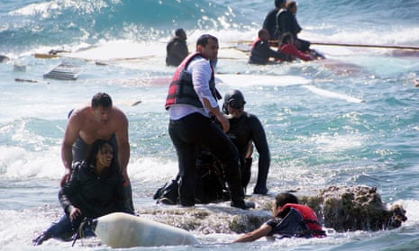 Greek islander Antonis Deligiorgis, left, pulls an Eritrean woman, Wegasi Nebiat, from the sea off Rhodes last year.
