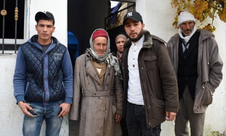 Mustapha Amri , second left, the father of Anis Amri, poses next to his children Walid, left, Hanan (C), and Abdelkader, and his brother, far right, in front of the family house in Oueslatia.