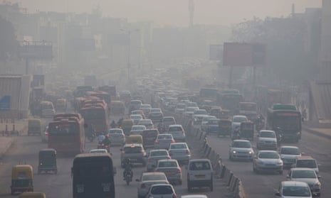 Heavy smog hangs over along a busy road in New Delhi. 