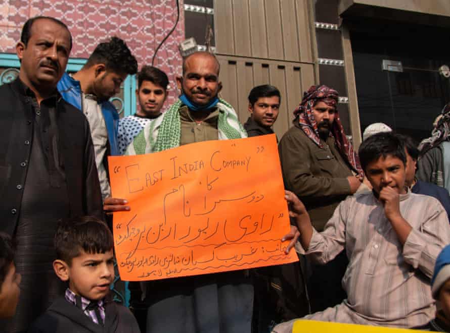 A resident of Ravi holds a placard that calls ravi river urban project East India Company