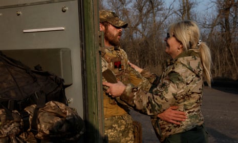 Two medics greet each other during intense shelling on Christmas Day at the frontline in Bakhmut.