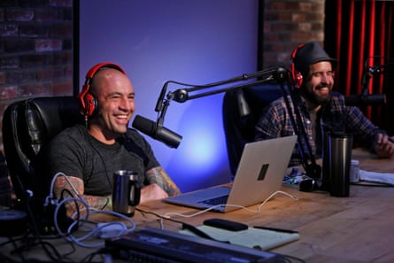 two men smiling at microphones