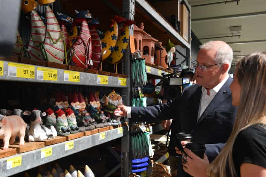 Prime minister Scott Morrison and first home buyer Nicole Rakitic buy a gnome during a visit to Bunnings in Malaga, Perth.