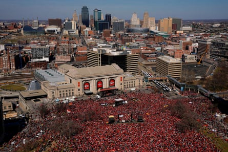 aerial view of huge crowd of people wearing red outside a station