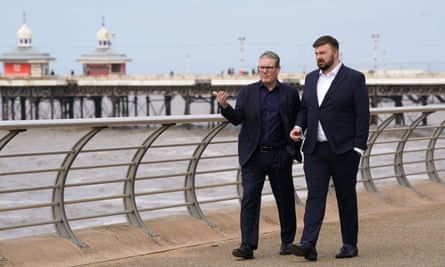 Keir Starmer walks with Chris Webb along the Blackpool seafront